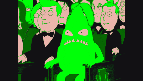 a group of people are sitting in a dark room with a green cartoon character in the middle