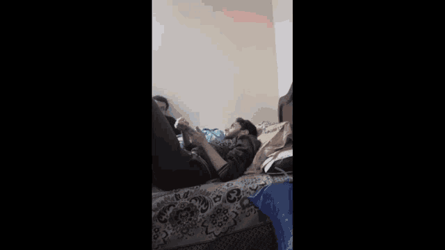 a man is laying on a bed with red eyes .