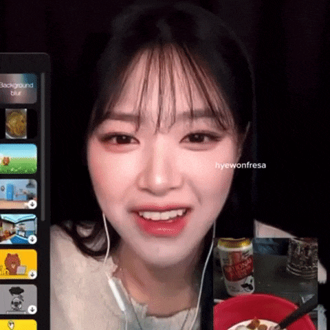 a girl with headphones is smiling in front of a screen that says background blur on it