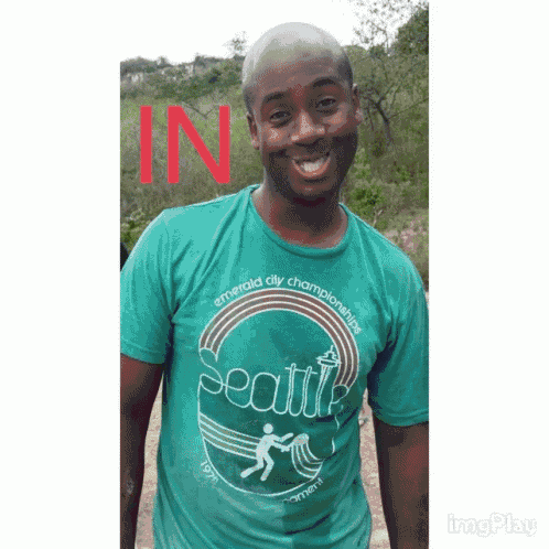 a man wearing a green shirt that says seattle