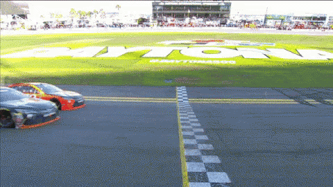 a race track with the word daytona written on the grass
