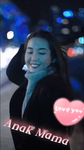 a woman is smiling with a pink heart that says anak mama on it