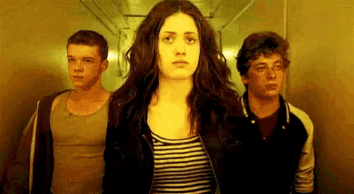 a group of people are standing next to each other in an elevator .