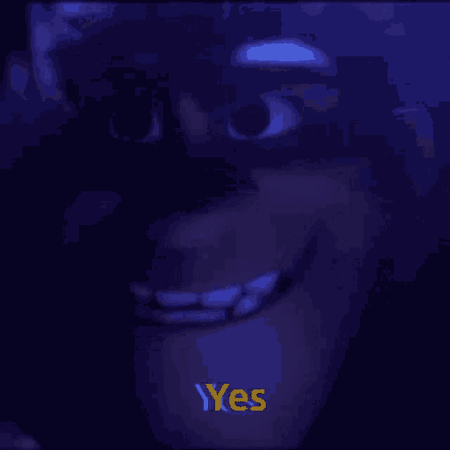 a close up of a cartoon character 's face with the words yes written in yellow .