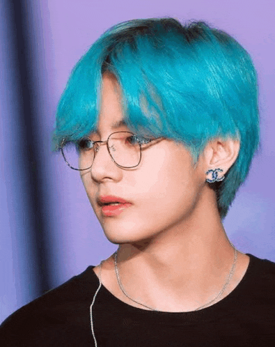 a young man with blue hair and glasses is wearing a black shirt .