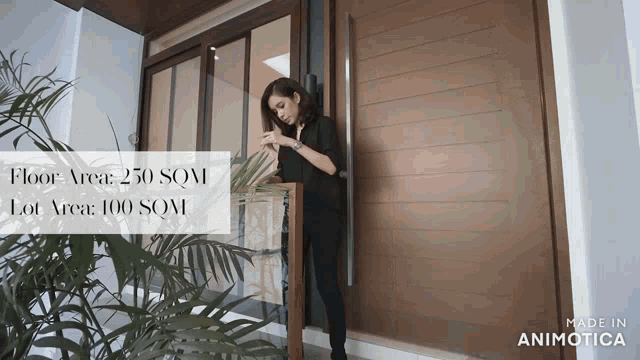 a woman is standing in front of a door that says floor area 250 sqm