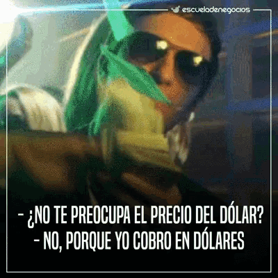 a man wearing sunglasses is holding a bunch of money in his hand