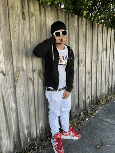 a person wearing sunglasses and a t-shirt that says ' falcon ' on it