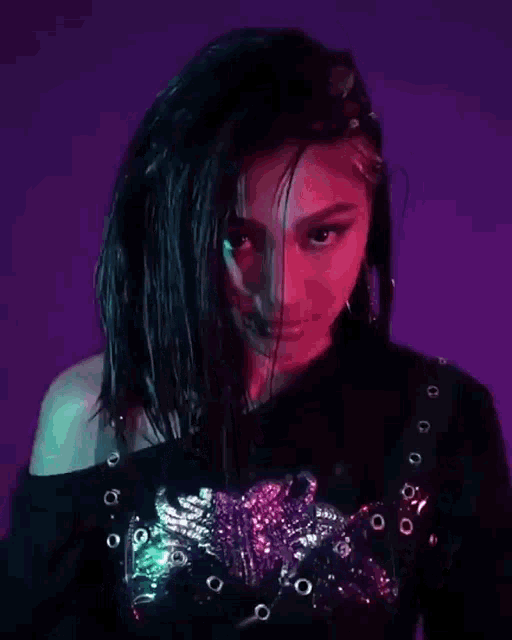 a close up of a woman 's face with a purple background .