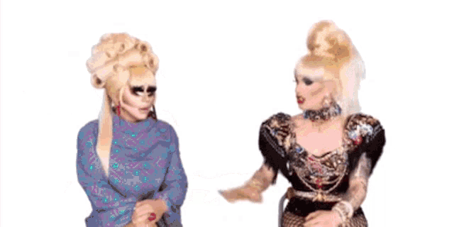 two drag queens are standing next to each other with the number 30 behind them