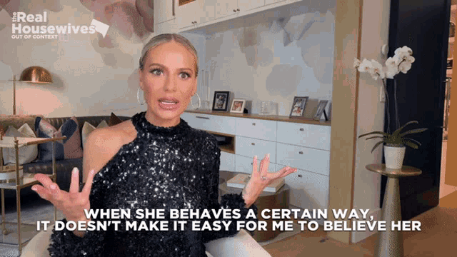 a woman in a black sequined dress is talking about a real housewives episode