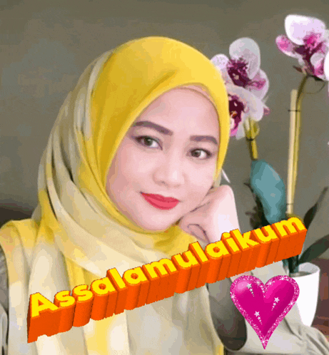 a woman wearing a yellow scarf with the words assalamualaikum written on it