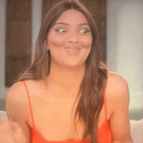 a woman in a red tank top is making a funny face