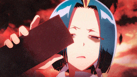 a person with blue hair is holding a piece of paper