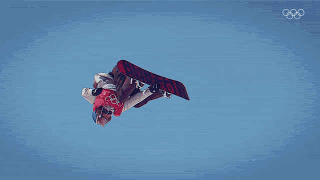a snowboarder is flying through the air with the word burton on his board