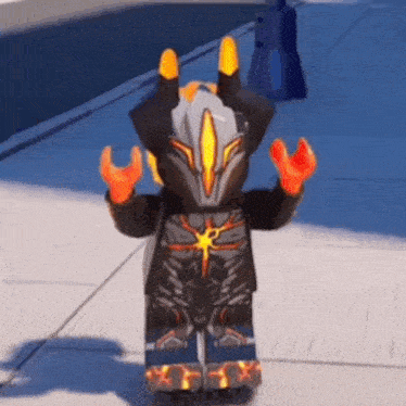 a lego figure is standing on a sidewalk with his hands up .