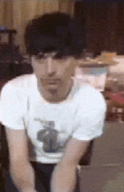 a man wearing a white t-shirt with a picture of a horse on it