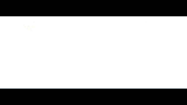 a silhouette of a person standing in front of a light beam