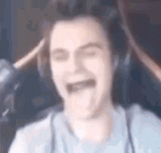 a blurry picture of a man wearing headphones making a funny face .