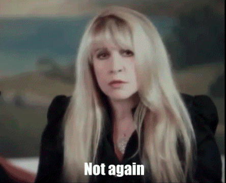 a woman with long blonde hair is wearing a black jacket and a necklace and says not again .