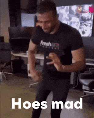 a man in a black shirt is dancing with the words hoes mad written on the bottom
