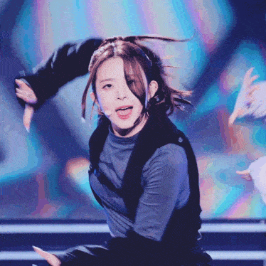 a girl with a ponytail is dancing on a stage
