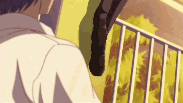 a man in a white shirt is standing next to a cat