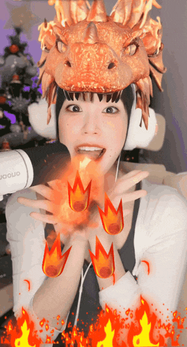 a woman wearing a dragon costume with fire coming out of her hand