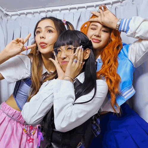 three girls are posing for a picture with one wearing a watch that says ' rolex ' on it