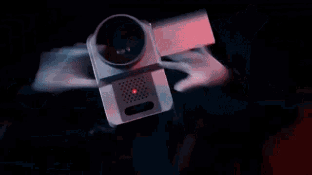 a person is holding a red light with a percentage sign on it
