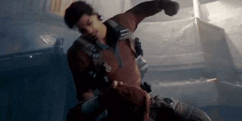 a man is punching another man in the face .