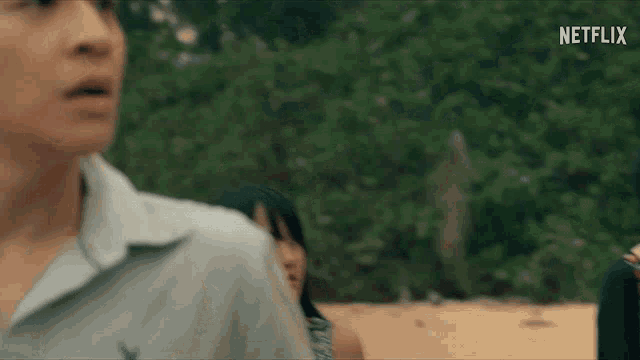 a man and a woman are standing next to each other on the beach .