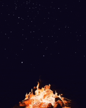 a large fire is burning in the dark