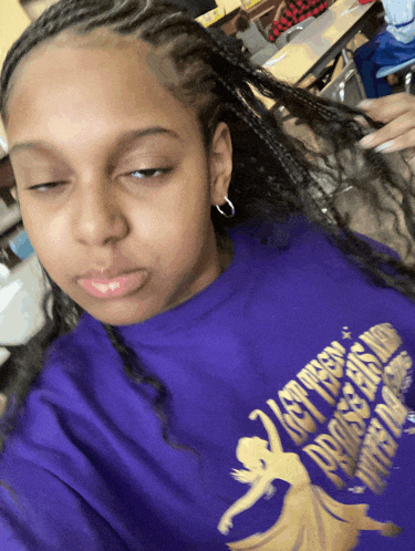 a girl wearing a purple shirt that says let freedom ring