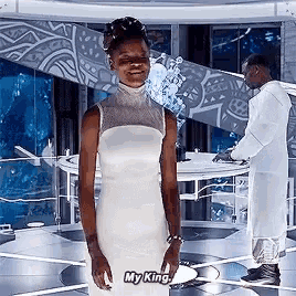 a woman in a white dress says my king in front of a man