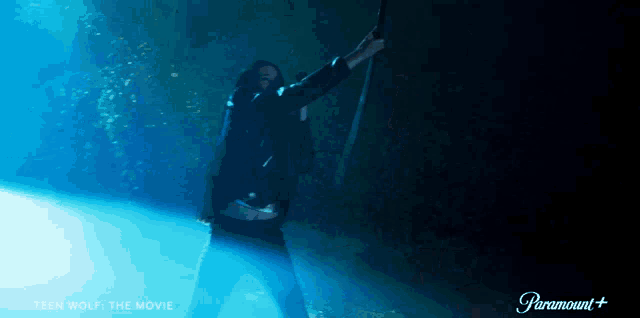 a poster for teen wolf the movie shows a man holding a gun
