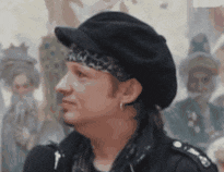 a man wearing a black hat and a leopard print headband