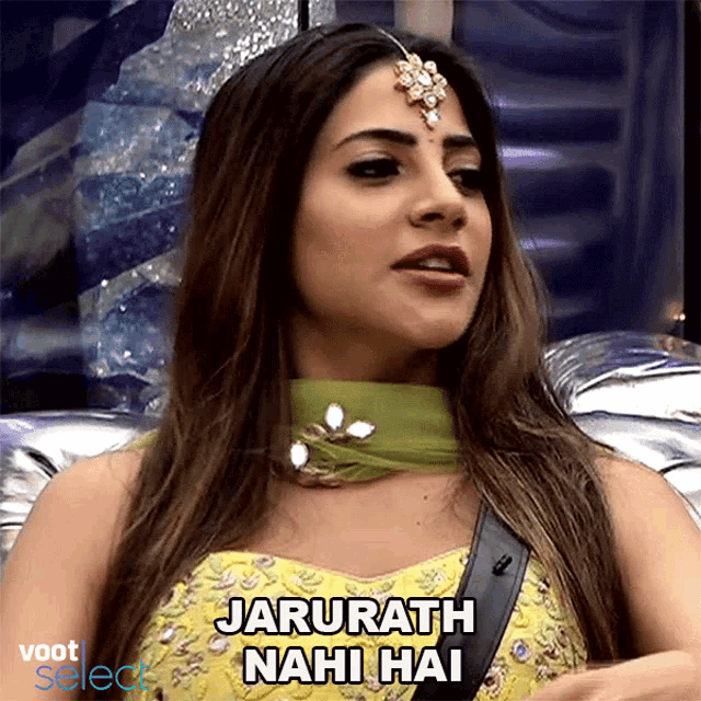 a woman is wearing a yellow dress and a green scarf and says " jarurath nahi hai "