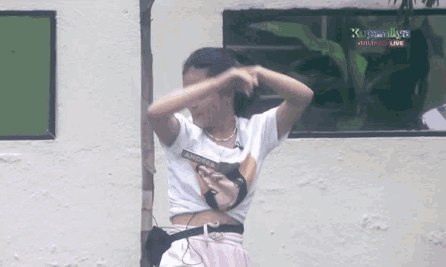 a woman wearing a crop top with andrea on it