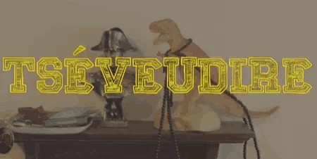 a statue of a dinosaur is on a table with the word tseyeudire