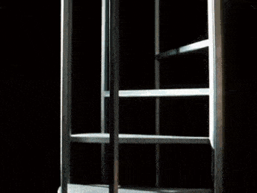a person is standing in a dark room holding a bag