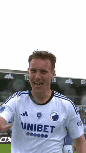 a soccer player wearing a white jersey with the word unibet on the front
