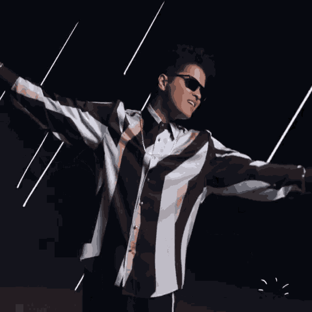 a man with his arms outstretched says good
