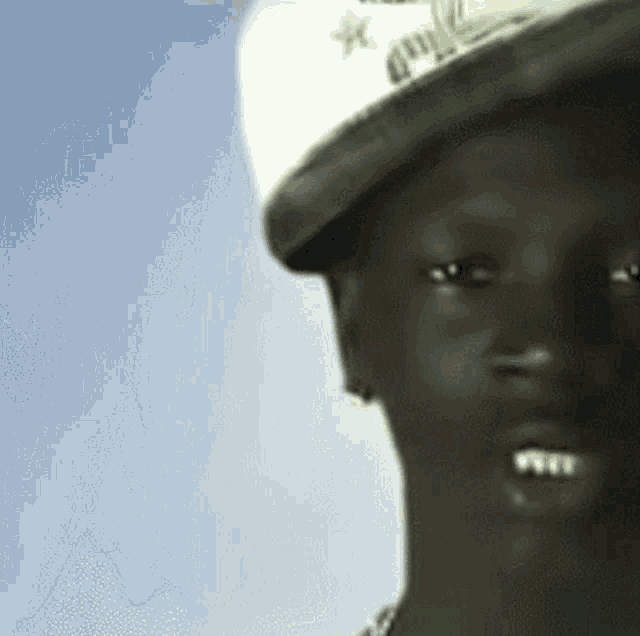 a close up of a man wearing a hat that says ' gmc ' on it