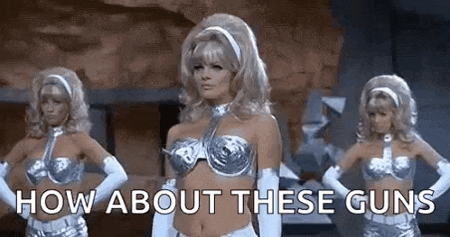 three women are standing next to each other with their hands on their hips and the words `` how about these guns '' above them .