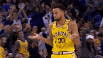 a basketball player wearing a yellow jersey that says warriors on it