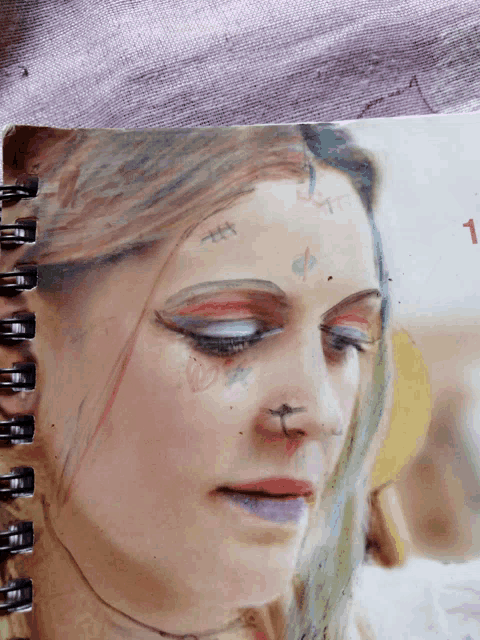 a drawing of a woman 's face has the number 1 on the bottom right
