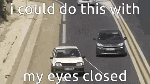 two cars are driving down a highway with the words `` i could do this with my eyes closed '' written on it .