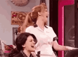 a woman is standing next to another woman in a room .