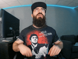 a man with a beard wears a t-shirt that says hello to my little friend